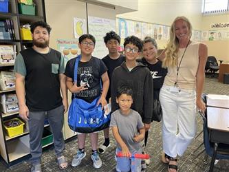 elementary student with teacher standing and smiling