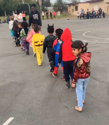 Preschool teacher and students walking