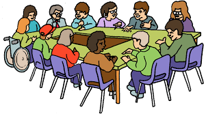 A variety of people sitting around a conference table